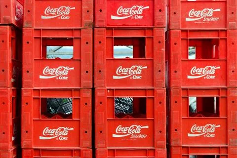 Empty Coca-Cola boxes stacked in one another. Stock Photos