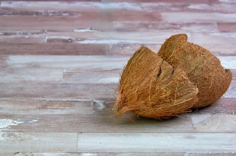 Empty coconut shell on a wooden table close-up with place for text Stock Photos