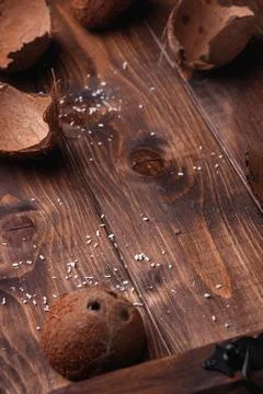 Empty coconut shells on a wooden table Stock Photos