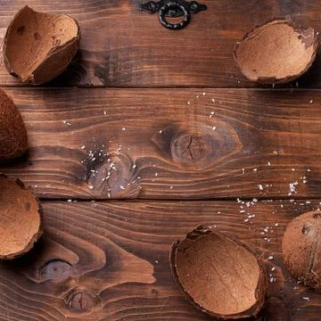 Empty coconut shells on a wooden table Stock Photos