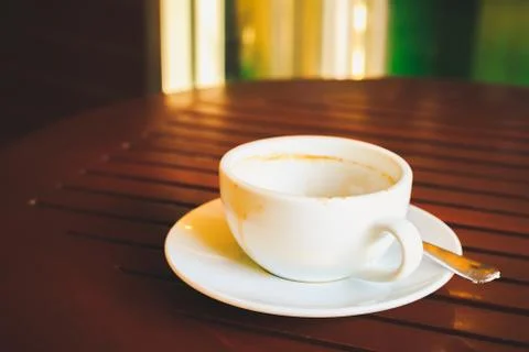 Empty coffee cup after drink on wood table. Stock Photos