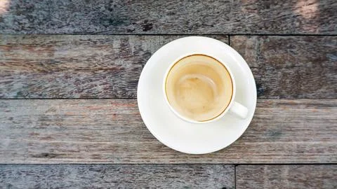 Empty coffee cup after drink on a wooden table. Stock Photos