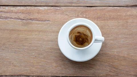 Empty coffee cup after drink on a wooden table. Stock Photos