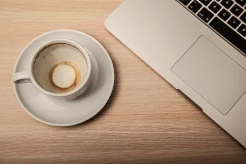 Empty coffee cup and computer on the office desk Stock Photos