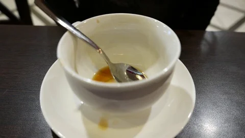Empty coffee cup and tea spoon, woman check it and put spoon on small dish Stock Footage 70606075