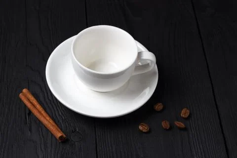 Empty coffee cup with a cinnamon stick on a black background Stock Photos