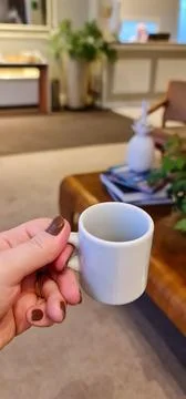 Empty coffee cup in a cozy setting Stock Photos