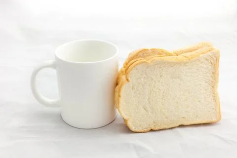 Empty coffee cup or coffee mug and sliced bread isolated on whit Stock Photos