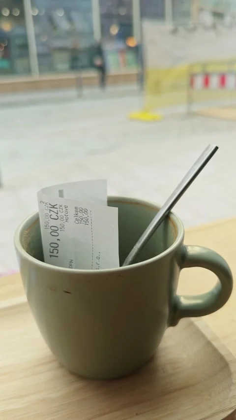 Empty Coffee Cup with Paid Receipt by Café Window Reflecting Everyday Urban Life Stock Footage 340280492