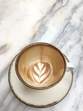 Empty coffee cup with remaining latte art foam after finished Stock Photos