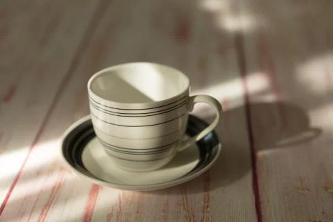 An empty  coffee or tea cup  place on old wooden table Stock Photos