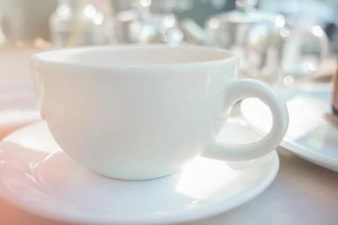 Empty coffee or tea cup on white table. White cup with hot drink on the morni Stock Photos