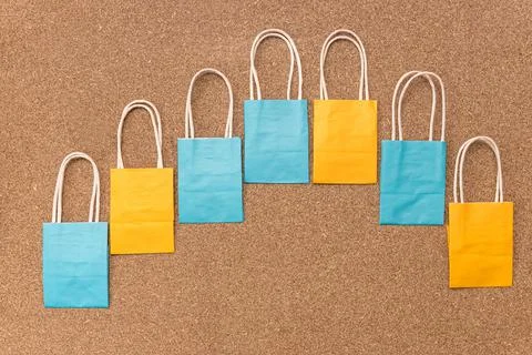Empty colourful paper packages in curved line Stock Photos