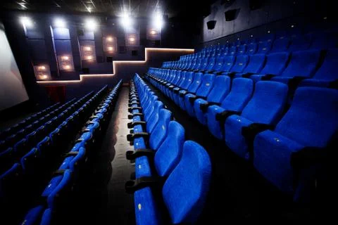 Empty comfortable blue seats with numbers in cinema Foto stock