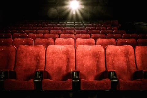 Empty comfortable red seats with numbers in cinema Stock Photos