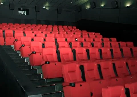 Empty comfortable red seats with numbers in moderncinema Stock Photos