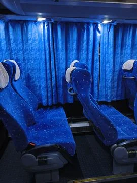 Empty comfortable seats inside a blue tourist bus Stock Photos