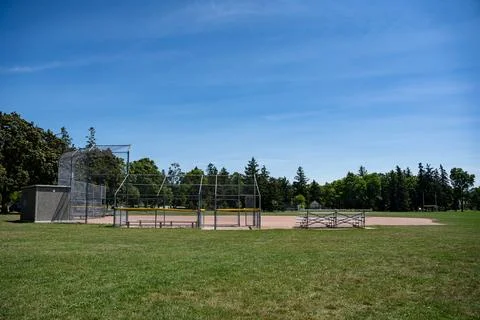 Empty community baseball field under blue sky Stock Photos