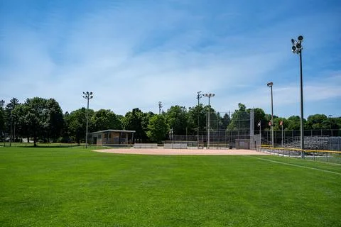 Empty community baseball field under blue sky Stock Photos