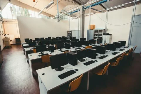 Empty computer class with modern computers on the desks in the school Stock Photos