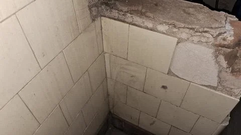 Empty concrete corner with exposed brick wall. Construction site or renovation Stock Photos