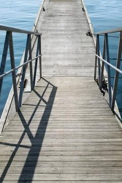 The empty concrete pier with steps with iron railing at the calm Stock Photos