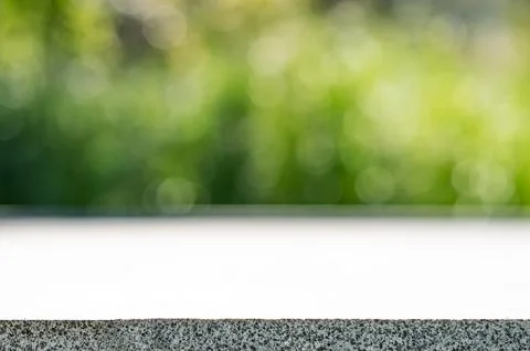 Empty concrete surface with blurred green park background and copy space Stock Photos
