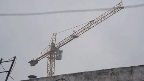 Empty construction crane on a cloudy and rainy day Stock Footage 125101449