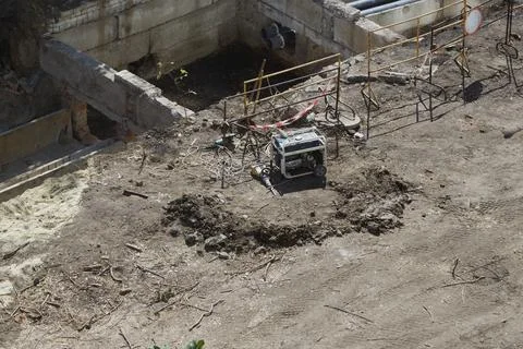 Empty construction site with a jackhammer and electric generator Stock Photos