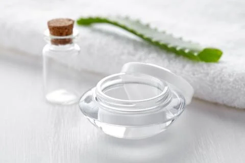 Empty container and bottle for cosmetic product with white towel Stock Photos