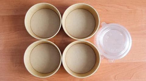 Empty containers arranged on a wooden table before a food preparation activity Stock Photos