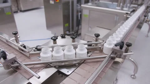 Empty containers on the drug assembly line. plastic vials move on the conveyor Video stock 200856950
