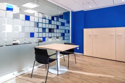 Empty conversation room with table and chairs in modern office interior. Stock Photos
