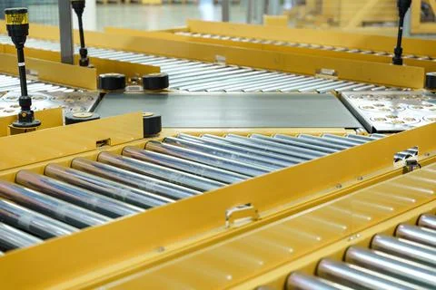 Empty conveyor sorting belt at distribution warehouse. Distribution hub for Stock Photos