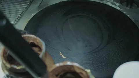 Empty cooking griddle with chocolate jars and utensils in view, ready for food Stock Footage 314084617