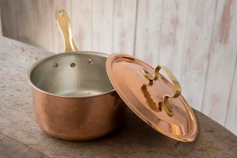 An Empty Copper Saucepan Alongside Lid Stock Photos