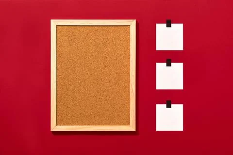 Empty cork board with blank notes on red background Stock Photos