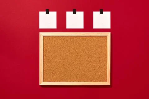 Empty cork board with blank notes on red background Stock Photos