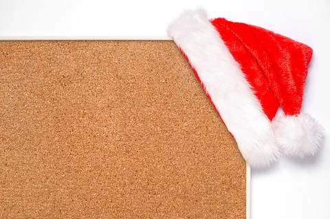 An empty cork board with a Santa hat. Making plans for the new year or a plac Stock Photos