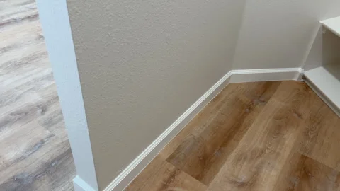 Empty corner with new wood laminate flooring Stock Footage 344935876