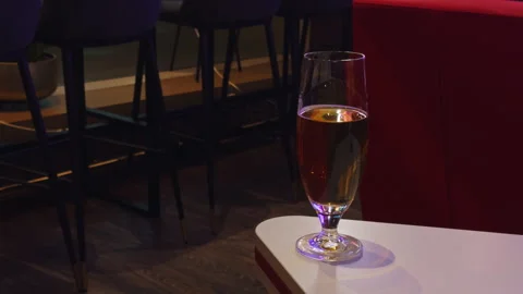 Empty corner table with dim lighting, An abandoned bar corner with muted lights Stock Footage 325126893