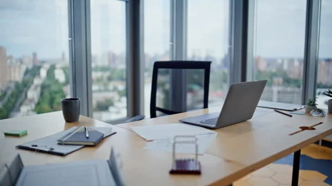 Empty corporate workspace laptop in office with city view. Workplace interior Stock Footage 319972498