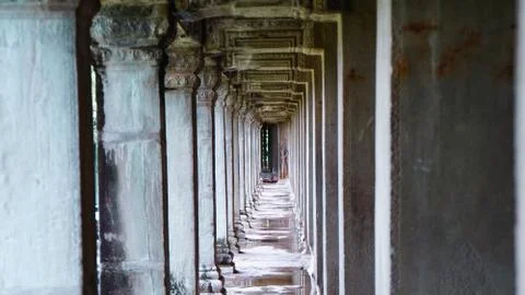 Empty corridor amidst old columns with diminishing perspective, in the ancien Stock Photos