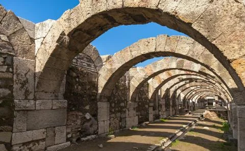 Empty corridor with arcs and blue sky. Ruins of Smyrna Stock Photos