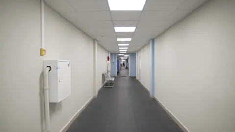 Empty corridor with doors and led lamps in modern hospital Stock Footage 313830565