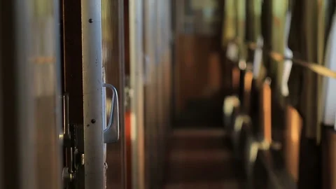 Empty corridor of railway carriage with coupe, the sun shines through the window Stock Footage 99323448
