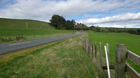 Empty country road with single car passing Stock Footage 54278945