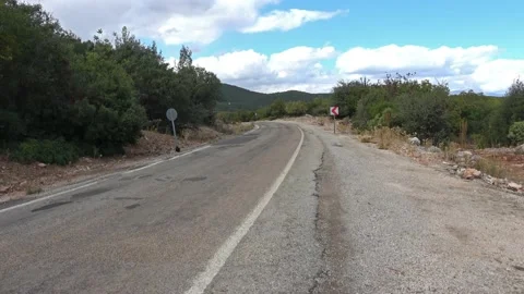 Empty countryside road via forest Stock Footage 197657650