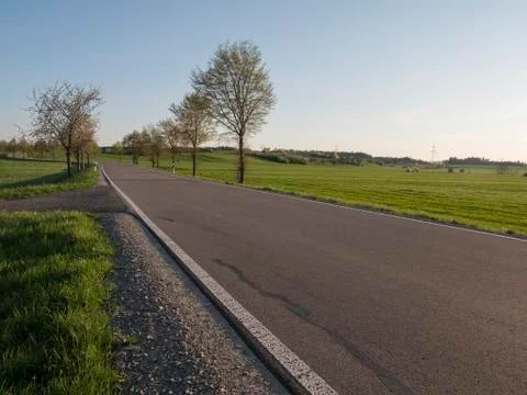 Empty countryside rural road in spring season background Stock Photos