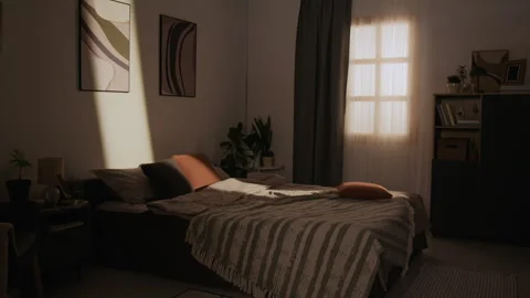 Empty Cozy Bedroom with Warm Sunlight Shining through Window Stock Footage 337904457